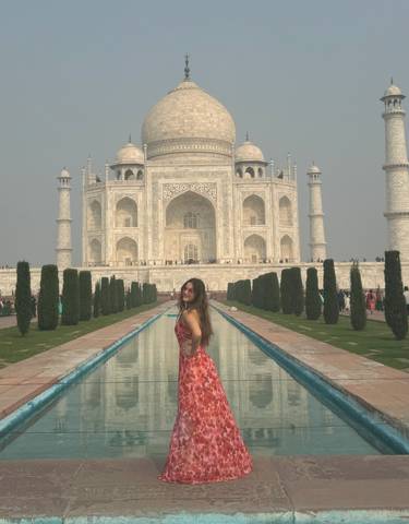 Person standing in front of the Taj Mahal.