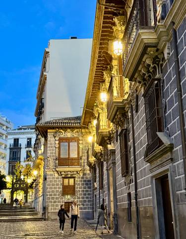 Ornate architecture of a historic building lit at dusk.
