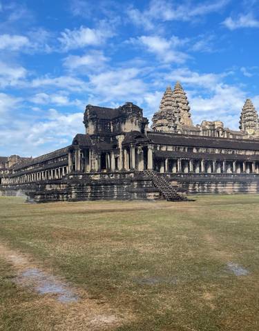 Wide-angle view of Angkor Wat with clear blue skies.