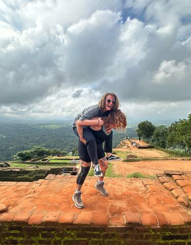 Two people playing in a scenic elevated landscape.
