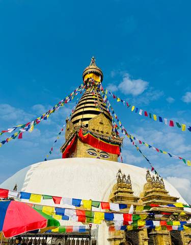 A stupa with colorful prayer flags.