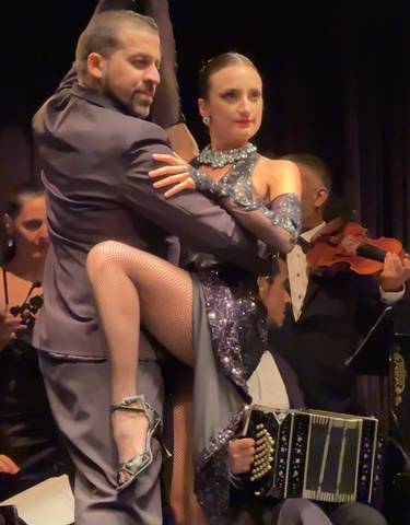 Tango dancers performing on stage.