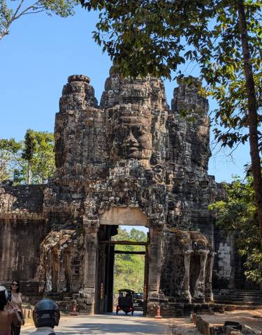 Ancient stone entrance with carved faces.