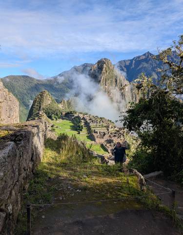 Scenic view of Machu Picchu with mist and greenery