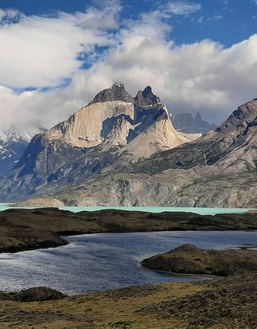 A lake with mountains and glaciers in the background.