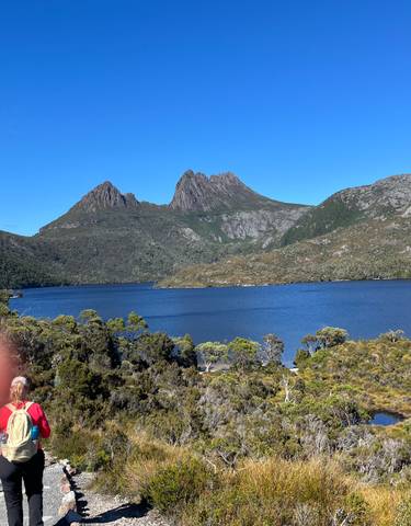 Lake with mountainous backdrop under a clear sky.