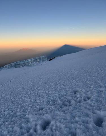 Shadow of Kilimanjaro cast on the clouds at sunrise.