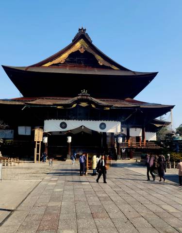 Large temple structure with people nearby.