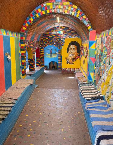 Colorful interior of a Nubian home with vibrant paintings.