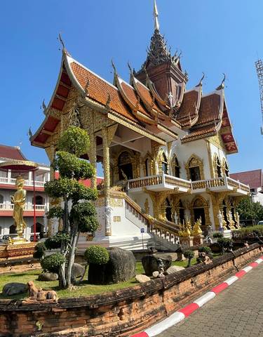 Ornately decorated temple building under clear sky.