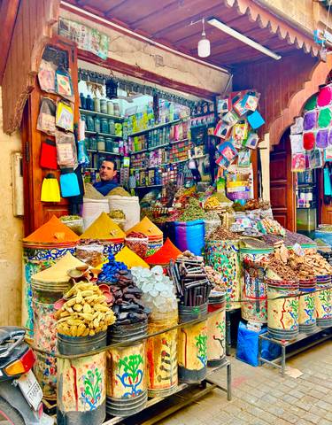 Colorful market stall with a variety of spices in Marrakesh.