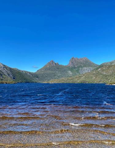 Mountainous landscape with a lake under blue sky