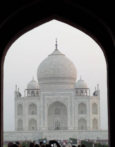 Close-up of the Taj Mahal dome framed by an arch.