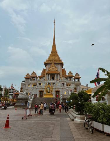 A grand temple with multiple tiers and golden spires.