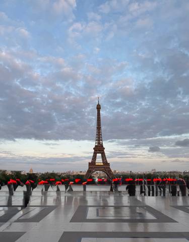 Eiffel Tower against a dramatic sky at sunset.