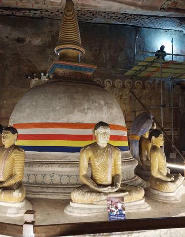 Buddhist shrine with statues and a stupa.