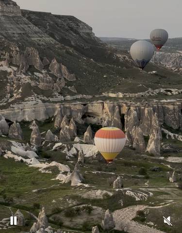 Colorful hot air balloon over rocky landscape.