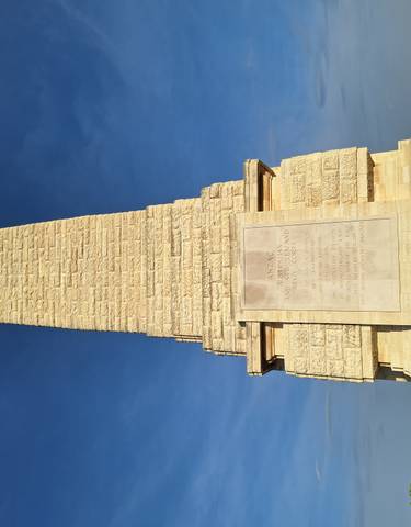 A memorial monument with engraved text, likely in Gallipoli.
