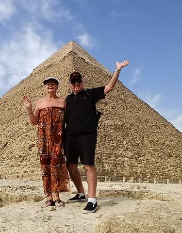 Two people posing in front of the Pyramid of Giza.