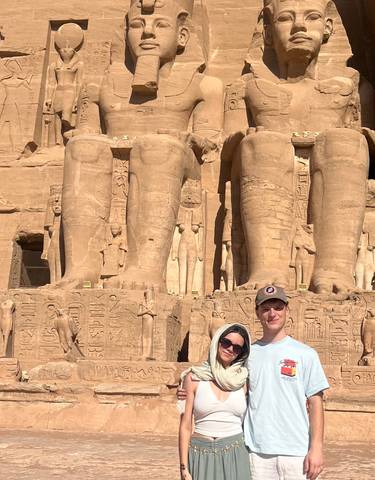Visitors posing in front of the statues at Abu Simbel.