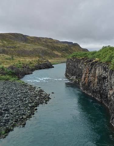 Wide river cutting through a rocky landscape.