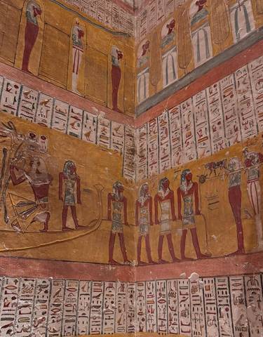 Ancient Egyptian hieroglyphs and murals on a temple wall.