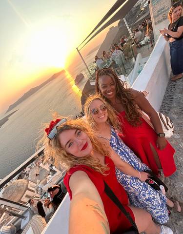 Group of friends enjoying sunset by the sea