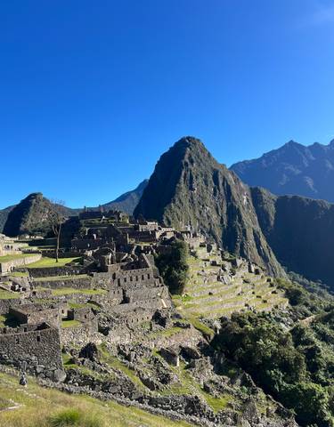 View of Machu Picchu with surrounding mountains.
