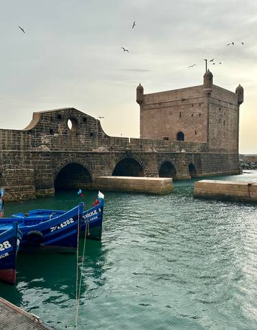 Historic fort and boats in the water at Essaouira.