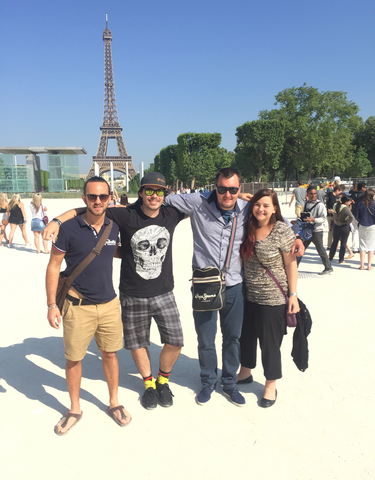 Group posing in front of the Eiffel Tower in Paris.