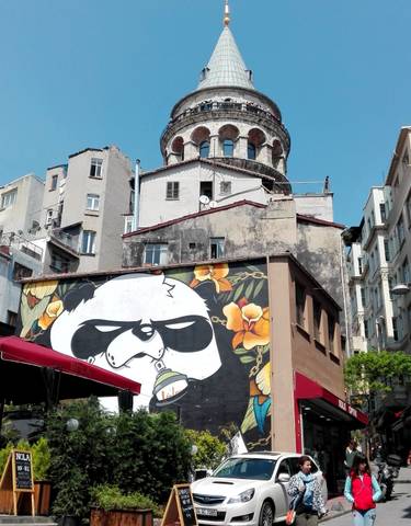 Street art on a building wall in an urban setting.