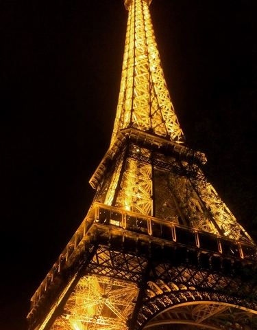 Eiffel Tower illuminated at night.
