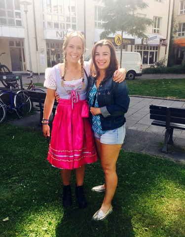 Two women posing in a park, one in traditional attire.
