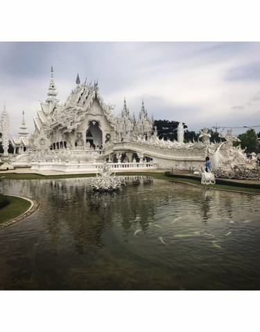The intricate White Temple with reflections in a pond.