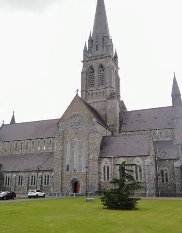 Large stone church with a tall spire.