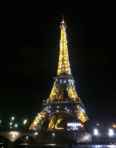 The illuminated Eiffel Tower at night.