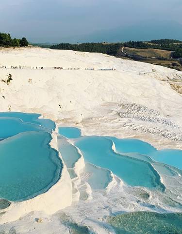 Capture of Pamukkale's white travertine terraces with pools.