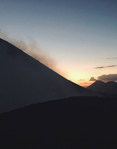 Silhouette of a mountain at sunset.