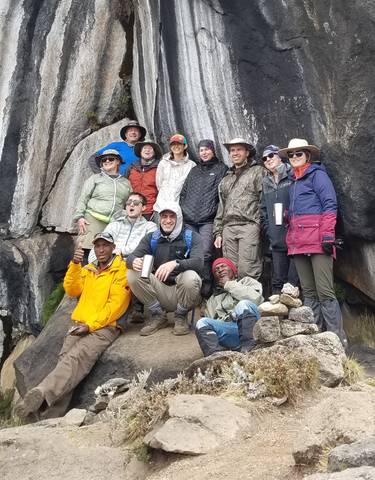 Group of hikers posing on a rocky mountain.
