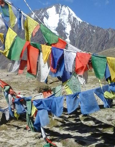 Colorful prayer flags in a mountainous area.