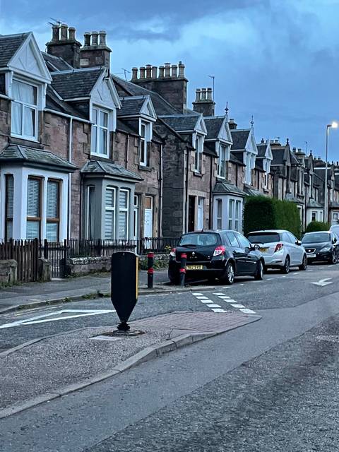       Upside-down image of houses and cars on a street.
  