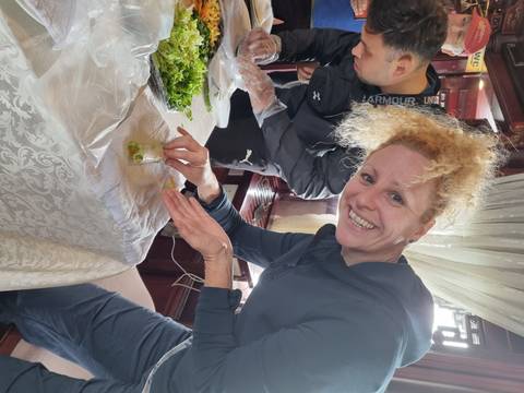 Woman preparing food at a table.