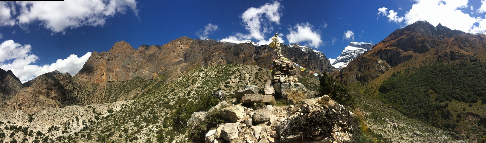 Mountain landscape with rocky terrain and prayer flags.