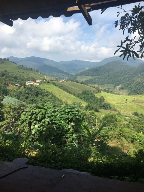 Lush green hills and valleys under a blue sky.