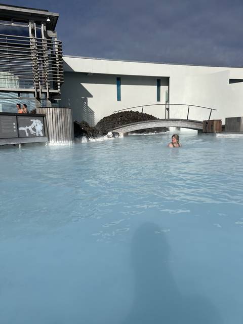       Person relaxing in a geothermal pool.
  