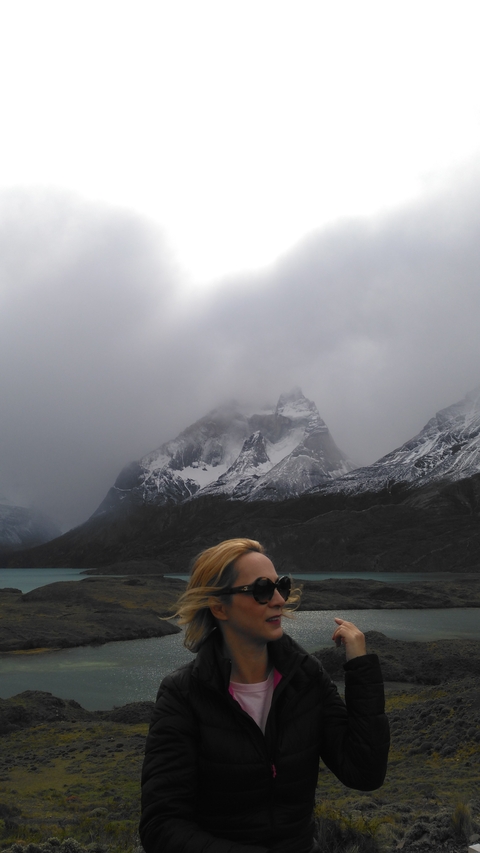       Cloudy mountain scenery with partial views of a person.
  