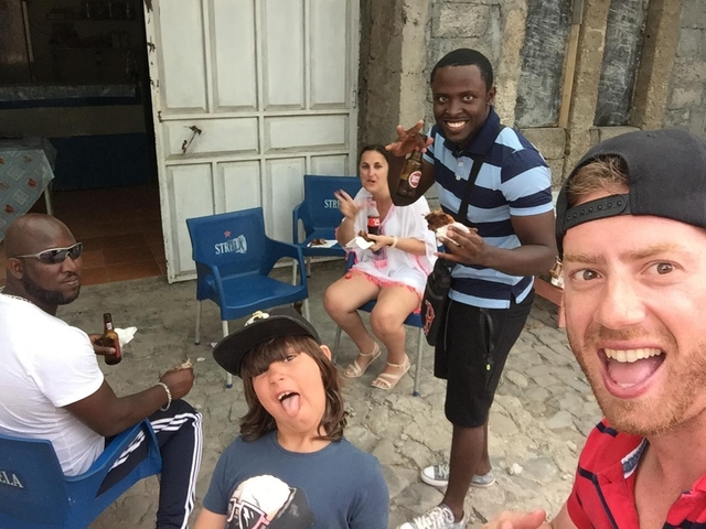       Group enjoying food and drinks outdoors.
  