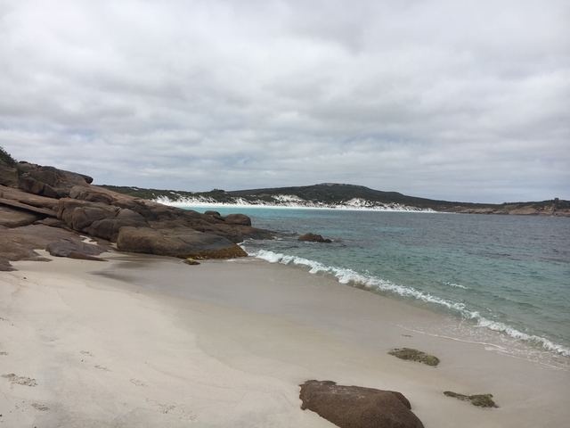 Beautiful beach scene with white sand and turquoise waters.