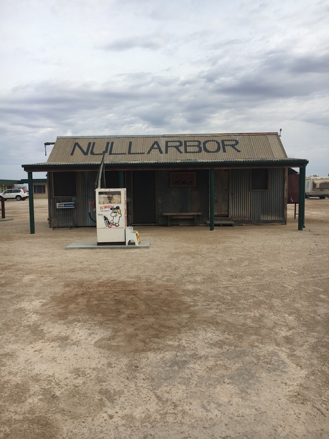 Outback rest stop with a sign for Nullarbor and an old petrol pump.