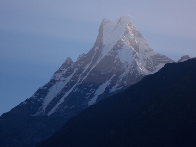 Snow-capped mountain peak under a clear sky.